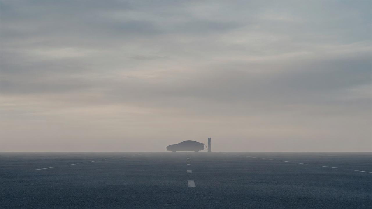 A lit charging monolith on a foggy horizon